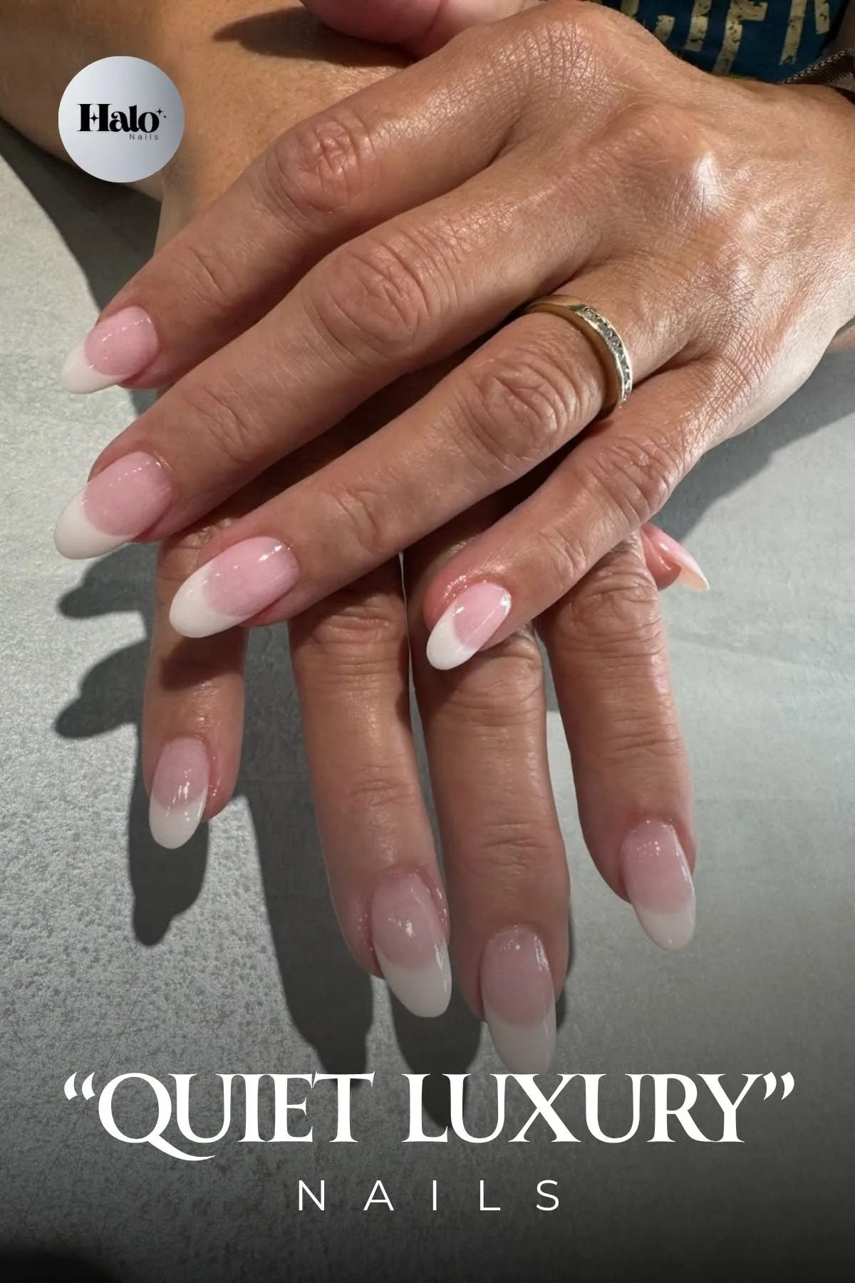 A French manicure with soft pink beds and pearl white tips, photographed at Halo Nails Spa under the words Quiet Luxury Nails